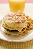 Cheeseburger with scrambled egg and fried potatoes
