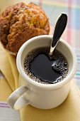 A mug of coffee and a muffin