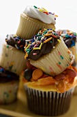 Colourful, decorated muffins in a pile