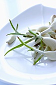 Cloves of garlic with shoots in a bowl