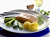 Poached salmon with boiled potatoes and leeks