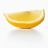 A lemon wedge with white background