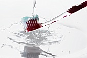 A toothbrush under running water