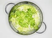 Fresh lettuce leaves in a colander