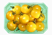 Yellow cherry tomatoes in a plastic punnet