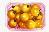 Yellow cherry tomatoes in a plastic punnet