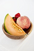Fruit bowl with melon, peach and strawberries