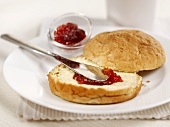 Bread roll with butter and jam