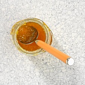 A jar of apricot jam with spoon