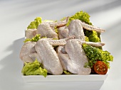 Raw chicken wings with salad garnish