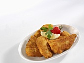 Three Wiener Schnitzels (veal escalopes) on a serving plate