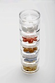 Various tablets in stacking pill boxes