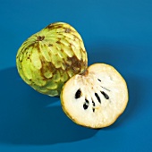 Whole and half cherimoya