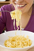 Woman eating ribbon pasta