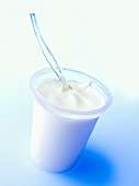 Plastic spoon in yoghurt pot