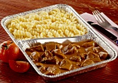 Beef goulash and pasta in aluminium dish