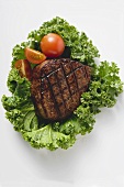 Grilled fillet steak on lettuce leaf
