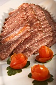 Platter of peppered salami with tomato flowers