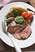 Beef steak with herb butter and baked vegetables