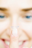 Contact lens on someone's finger