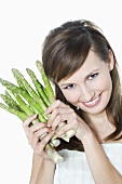 Young woman with green asparagus