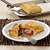Puff pastry pasties with ham and tomato filling