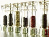 Various types of pepper in several peppermills
