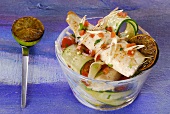 Fried trout fillet on tomato and cucumber salad