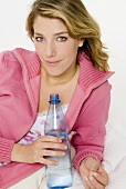 Young woman holding a bottle of water in her hand
