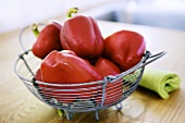 Red peppers in a wire basket