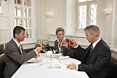 Man proposing a toast at a business meal