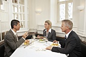 Three business people having a meal together