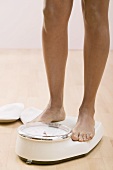 Young woman on bathroom scales