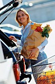 Woman food shopping with shopping trolley