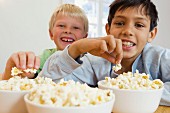 Two boys eating popcorn