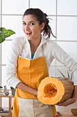 Woman with cut pumpkin