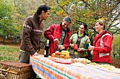 Two couples on an autumn picnic (outside)