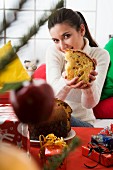 Woman at Christmas holding a piece of panettone