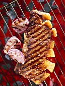 Sirloin steak with onions on a barbecue