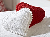 Two small heart-shaped cushions (red and white)
