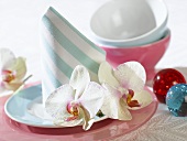 Place-setting with napkin and orchids