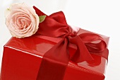 Gift in red wrapping paper with rose