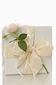 Gift in white wrapping paper with rose