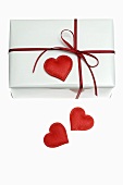 Gift in white wrapping paper with red heart