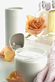 Aroma lamp, rose and jar of cream