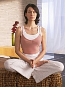 Woman sitting cross-legged practising yoga