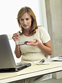 Woman eating sushi at her desk