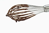 Whisk covered in chocolate icing