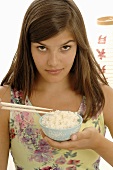 Woman eating rice with chopsticks