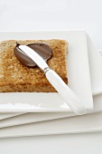 Spreading chocolate spread on toast